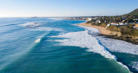 Aerial view of Atlantic waves breaking in south Spain at a winter evening. Surfer swell waves breaking elegantly