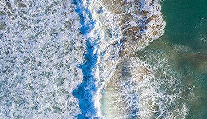 Aerial view of Atlantic waves breaking in south Spain at a winter evening. Surfer swell waves breaking elegantly