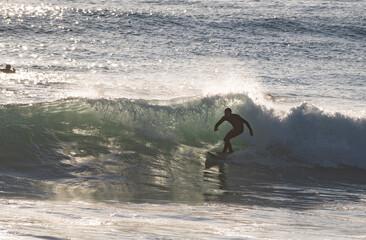 Young man surfing wave in Cadiz, Andalusia