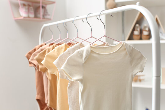 Hangers with Baby Clothes on Rack Stock Photo - Image of garments, inside:  132793586