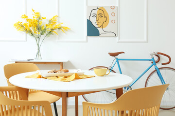 Interior of modern room with table, chairs and bicycle