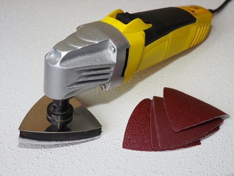 Heavy duty oscillating multitool with sanding pad. Sand paper for oscillating multitool. Grinding and polishing tool 