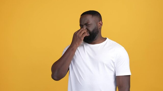 Guy close finger nose intolerable smell isolated shine color background