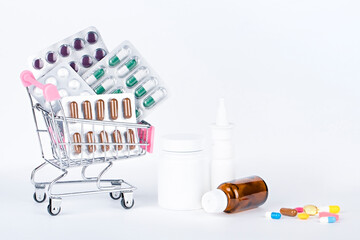 medical pills and medicines in a trolley on a light background