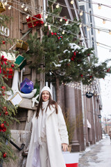 A young stylishly dressed girl on holidays New Year, Christmas on the streets of the city.
