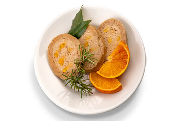 Rolled up chicken cooked with orange juice, three slices of rolled chicken with orange and rosemary slices and bay leaves, top view, isolated on white, clipping path
