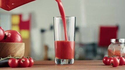 Woman pouring tomato juice, fresh red vegetable juice on kitchen table, vitamin c, italian and Spanish cuisine, gazpacho