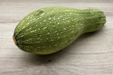 Fresh raw zucchini isolated on wooden background