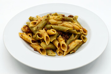 Italian Maccheroni al pettine al ragù. Colored pasta dish.