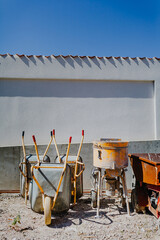 View of construction place wheelbarrow cement mixer