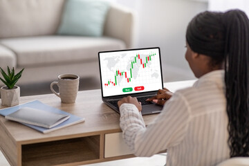 Successful black woman trading online while staying home