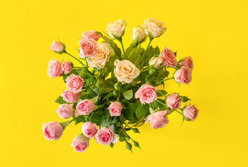 Bouquet of beautiful roses on yellow background