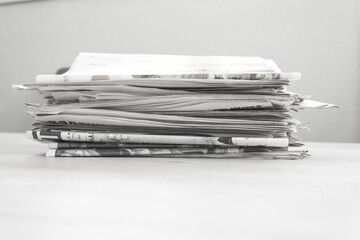A stack of newspapers. Business news, finance. Latest information. Copy space