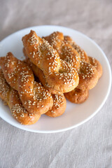 Kaak malih, a traditional Libyan salted cookie with sesame seeds, which comes in the shape of braid. Adapted keto dessert made from almond flour and mozzarella.