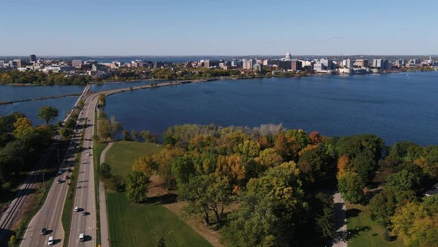 Flying Over John Nolen Drive towards Downtown Madison, Wisconsin Surrounded by Fall Colors (Drone - Push In)