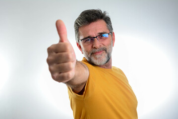 Happy handsome mature man showing thumbs up