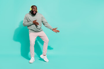 Full length body size view of cheerful attractive guy dancing copy blank space isolated over shine teal turquoise color background