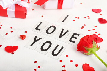 Text I LOVE YOU, rose flower and gifts for Valentine's Day on light background