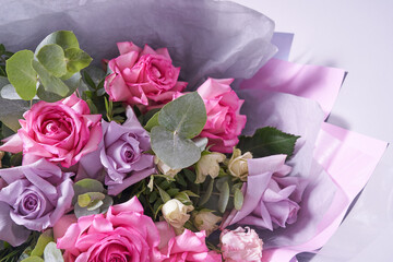 Close-up of a colorful bouquet of flowers. Big pink roses. On a light background, top view, copy space. High quality photo