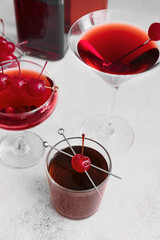 Glasses of tasty Manhattan cocktail on light background