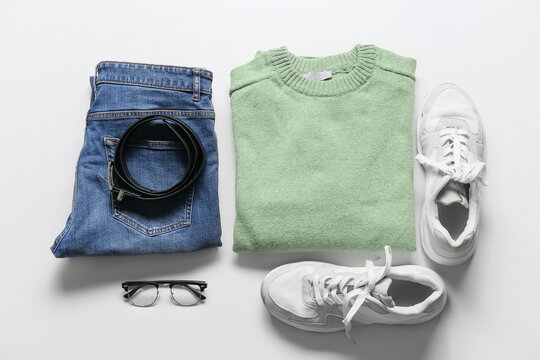 Stylish male clothes, shoes, eyeglasses and belt on light background