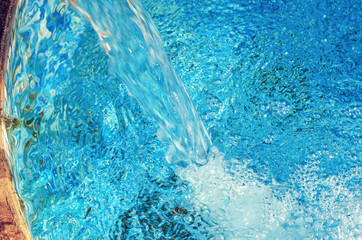 Falling stream of fresh clean spring water. Energy of nature.