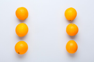 Ripe fresh oranges on white background