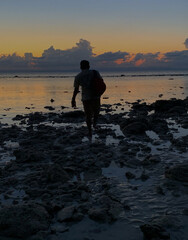 person on the beach at sunset