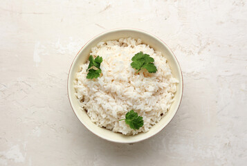 Bowl with tasty boiled rice on light background