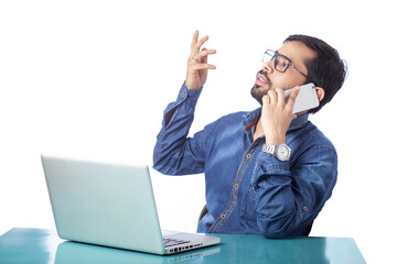 corporate man distracted from laptop work and talking on cell phone