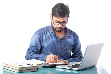 young businessperson writing on notepad or diary while working on laptop or computer