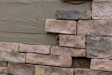 Making texture of wall facing with decorative stone tiles bricks