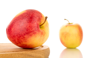 Three red juicy apples on a wooden tray, macro, isolated on white.