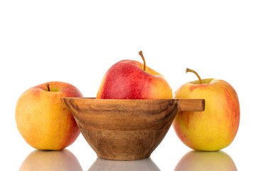 Three red juicy apples with a wooden cup, macro, isolated on white.