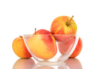 Four red juicy apples with glassware, macro, isolated on white.
