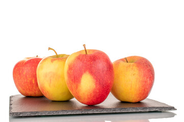 Four red juicy apples on a slate stone, macro, isolated on white.