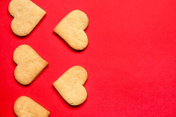 Tasty heart shaped cookies on red background. Valentines Day celebration