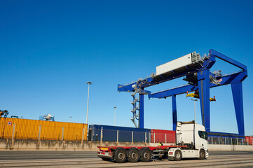 Container truck in the port of Bilbao with containers and crane in the background