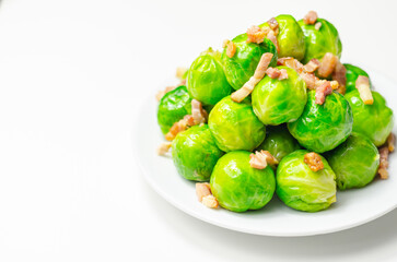 Tasty brussels sprouts with smoked bacon lardons and salted butter
