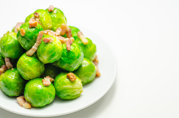 Tasty brussels sprouts with smoked bacon lardons and salted butter