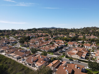 Fototapeta na wymiar Aerial view over street with identical houses in the suburb of North San Diego, South California, USA. 