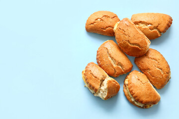 Tasty sochniki with cottage cheese on blue background