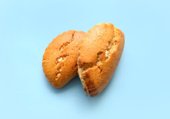 Tasty sochniki with cottage cheese on blue background