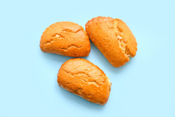 Tasty sochniki with cottage cheese on blue background