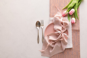 Beautiful table setting with pink tulips on light background