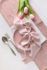 Beautiful table setting with pink tulips on light background