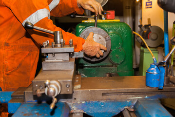 Turner worker at work on a lathe.
