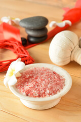 Bowl with sea salt on wooden background. Valentine's Day celebration