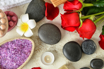 Beautiful roses, spa stones and sea salt on beige background. Valentine's Day celebration