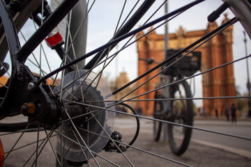 bicycle wheel in the street
Detail ofbicycle wheel in front of a building
detail of a bicycle in...